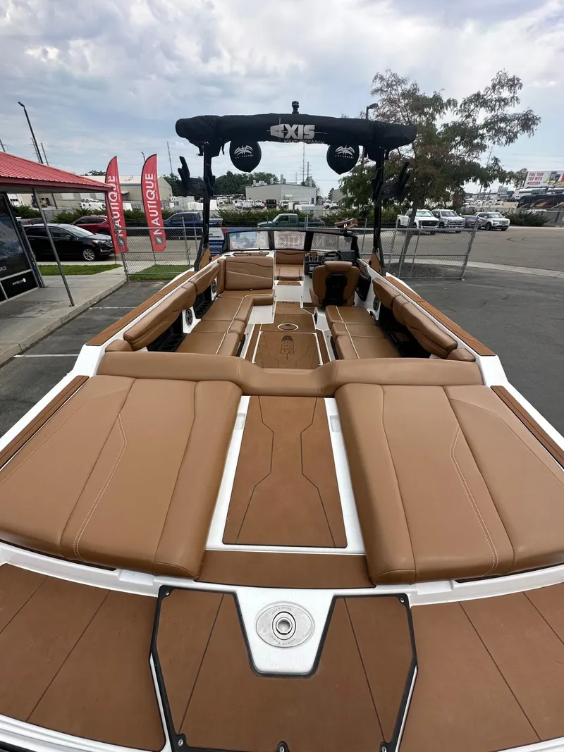 Slide: The Image of 2023 Axis T250 boat with tan seating, docked outdoors. - 9