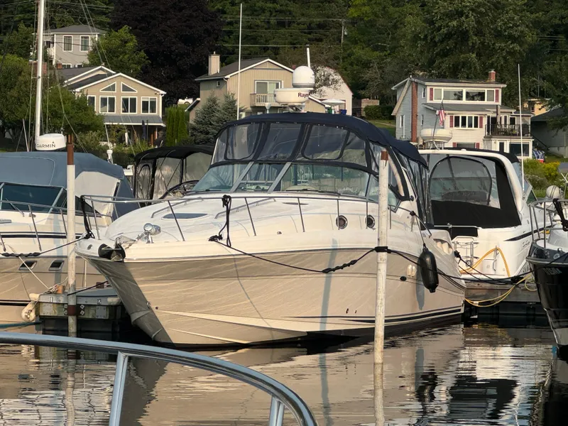 The Image of 2007 Sea Ray 340 Sundancer docked at marina with waterfront homes in background. - 0