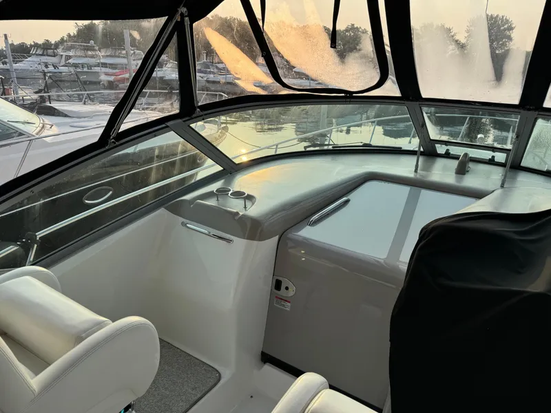 Slide: The Image of 2007 Sea Ray 340 Sundancer cockpit with helm, marina view at sunset. - 10