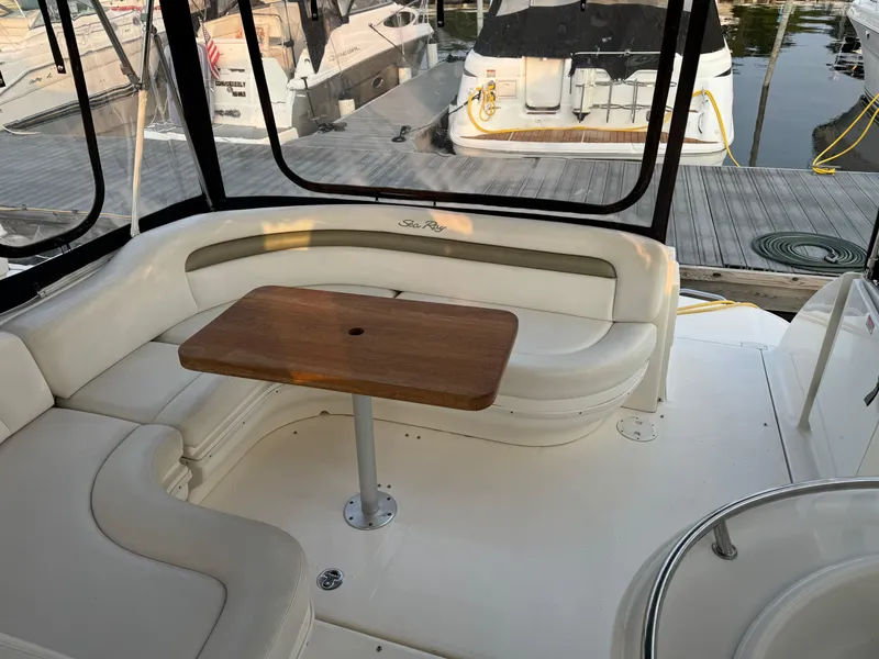 Slide: The Image of Interior of 2007 Sea Ray 340 Sundancer with seating and wooden table. - 12