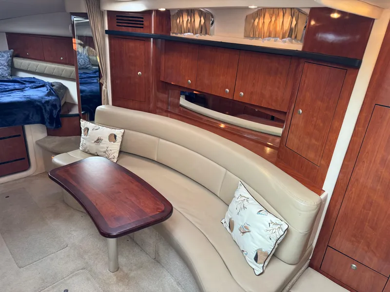 Slide: The Image of Luxurious interior of 2007 Sea Ray 340 Sundancer with curved seating and wooden cabinetry. - 14