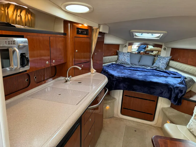 Slide: The Image of Luxurious interior of 2007 Sea Ray 340 Sundancer yacht with kitchenette and cozy sleeping area. - 15