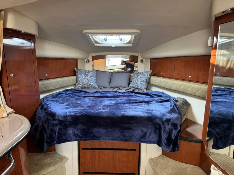 Slide: The Image of 2007 Sea Ray 340 Sundancer cabin with cozy bed and elegant wood paneling. - 16