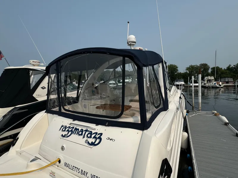 Slide: The Image of 2007 Sea Ray 340 Sundancer docked at marina, rear view with canopy. - 2