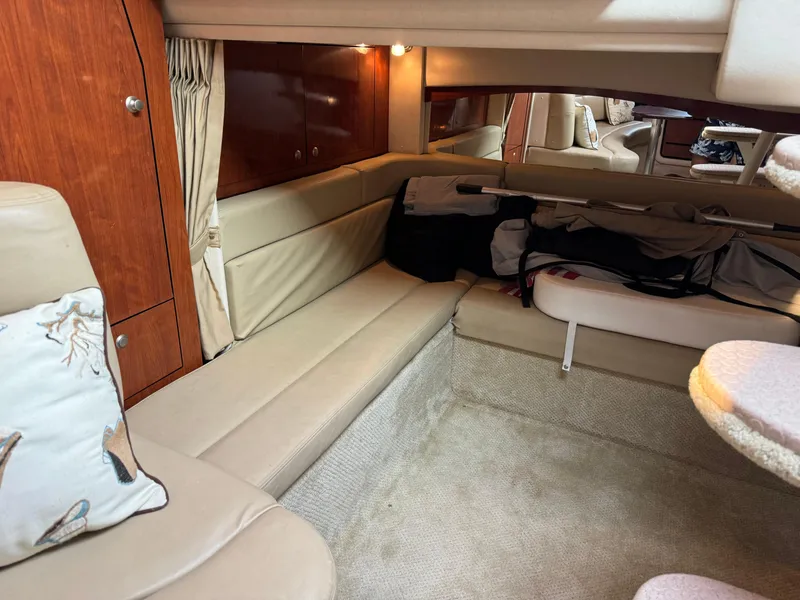 Slide: The Image of Interior of 2007 Sea Ray 340 Sundancer with beige seating and wooden cabinetry. - 21