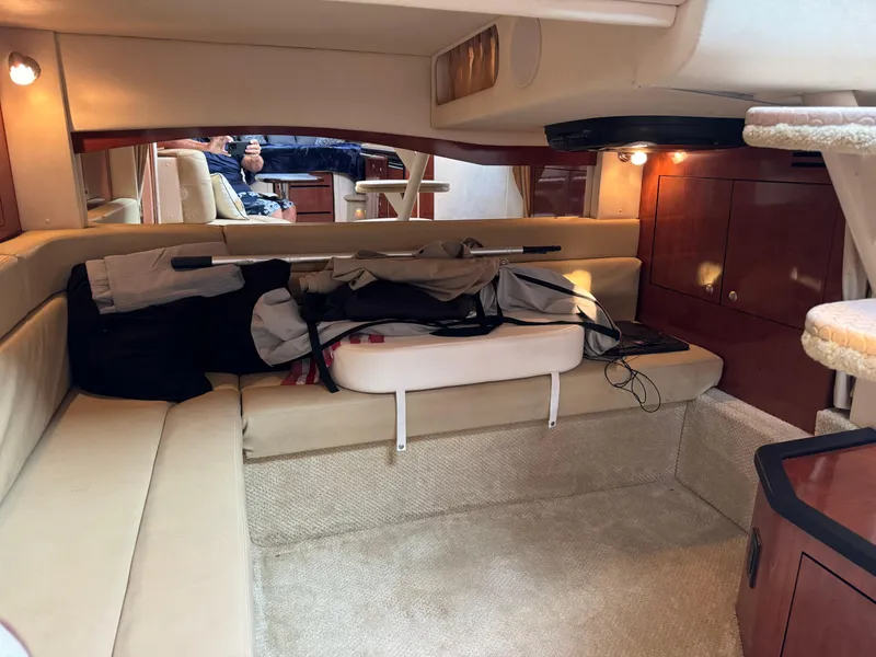Slide: The Image of Interior of 2007 Sea Ray 340 Sundancer with beige seating and wooden cabinetry. - 22