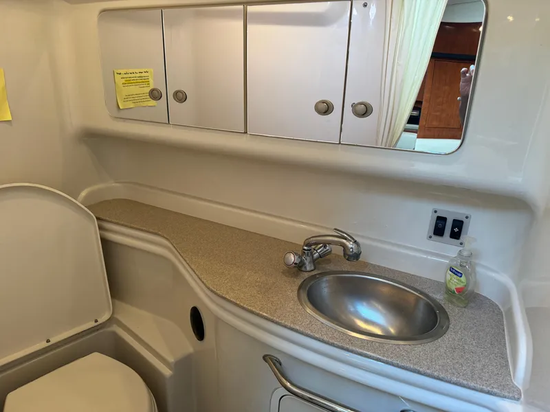 Slide: The Image of 2007 Sea Ray 340 Sundancer bathroom with sink, mirror, and storage cabinets. - 24