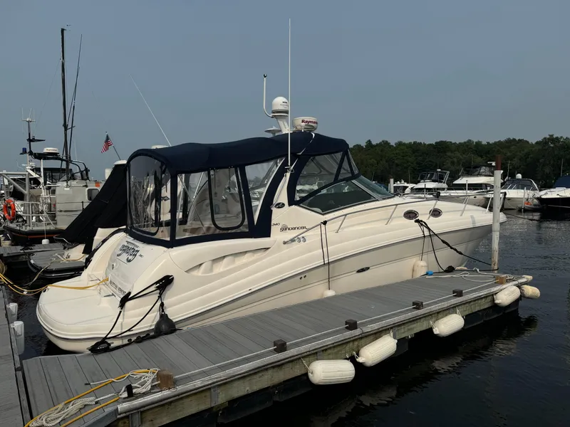 Slide: The Image of 2007 Sea Ray 340 Sundancer docked at marina, featuring sleek design and covered cockpit. - 4