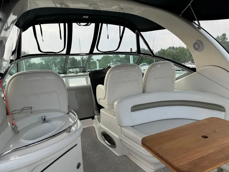 Slide: The Image of 2007 Sea Ray 340 Sundancer interior with seating, sink, and wooden table. - 5