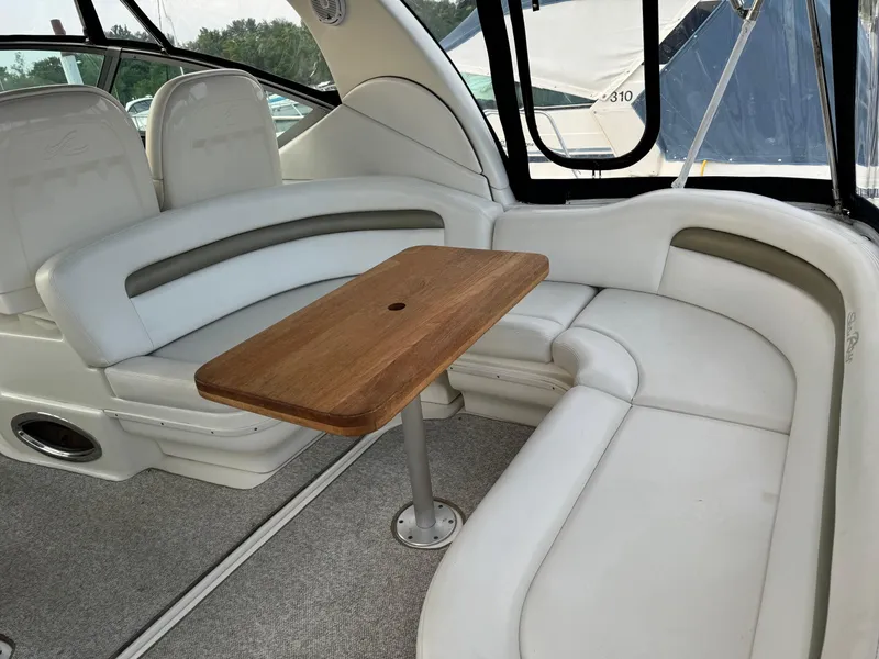 Slide: The Image of Interior of 2007 Sea Ray 340 Sundancer with white seating and wooden table. - 6