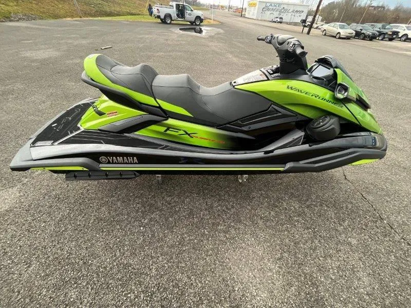 Slide: The Image of 2024 Yamaha Waverunner FX Cruiser SVHO, green and black, with audio system, parked on asphalt. - 20