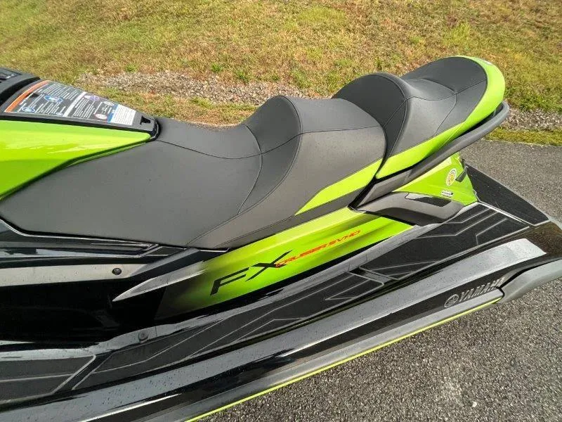 Slide: The Image of 2024 Yamaha Waverunner FX Cruiser SVHO, green and black seat detail, on pavement. - 24