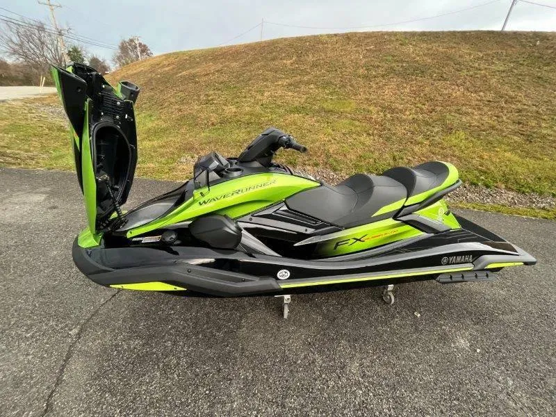 Slide: The Image of 2024 Yamaha Waverunner FX Cruiser SVHO with Audio System, green and black, parked outdoors. - 33