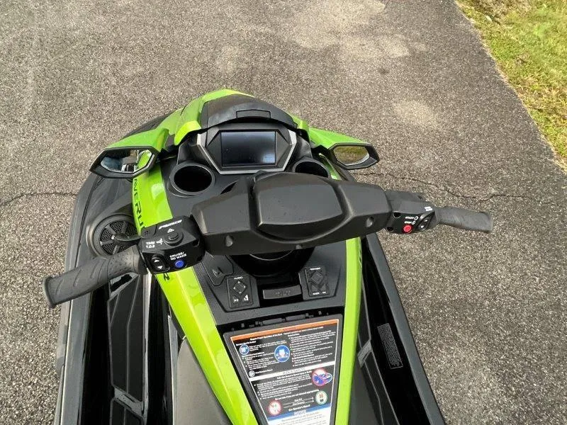 Slide: The Image of 2024 Yamaha Waverunner FX Cruiser SVHO dashboard with audio system, green and black design. - 34
