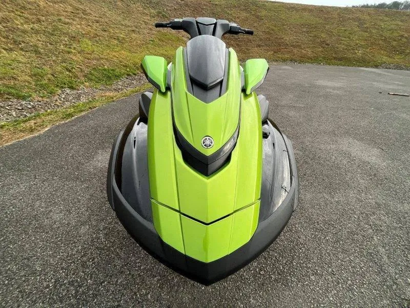 Slide: The Image of 2024 Yamaha Waverunner FX Cruiser SVHO, lime green, front view on pavement. - 4