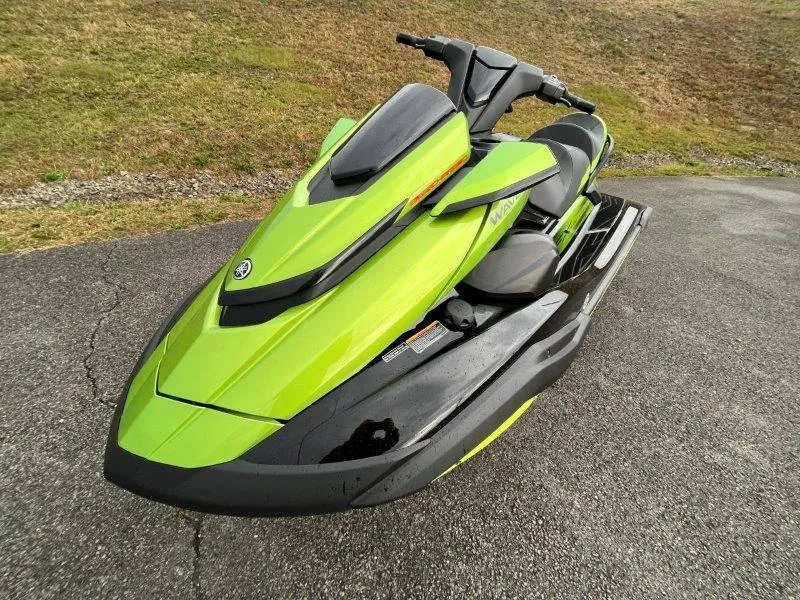 Slide: The Image of 2024 Yamaha Waverunner FX Cruiser SVHO, lime green, parked on asphalt. - 5