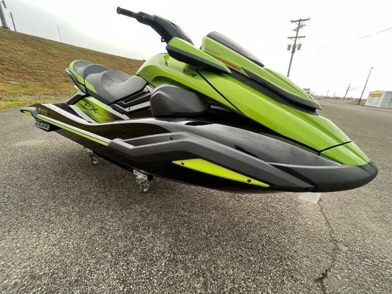 Slide: The Image of 2024 Yamaha Waverunner FX Cruiser SVHO, lime green, parked on pavement. - 6