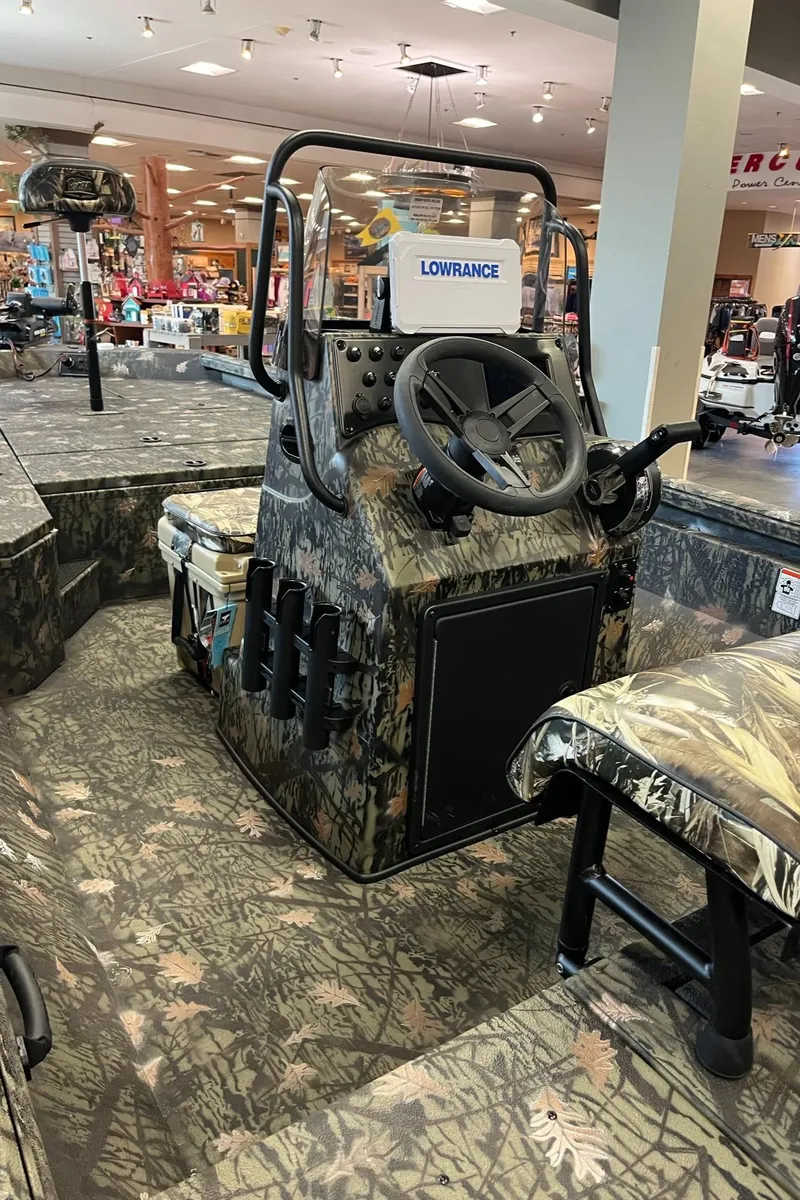 Slide: The Image of 2024 Ranger RB210 boat interior with camouflage design and steering console. - 6