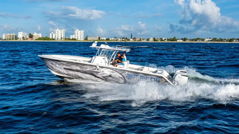 Slide: The Image of 2018 SeaHunter 39 Tournament boat cruising on ocean near city skyline. - 11