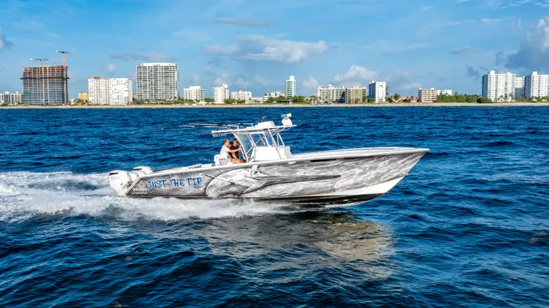 Slide: The Image of 2018 SeaHunter 39 Tournament boat cruising on ocean near city skyline. - 14