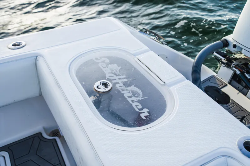 Slide: The Image of SeaHunter 39 Tournament 2018 boat deck with logo, near water. - 25