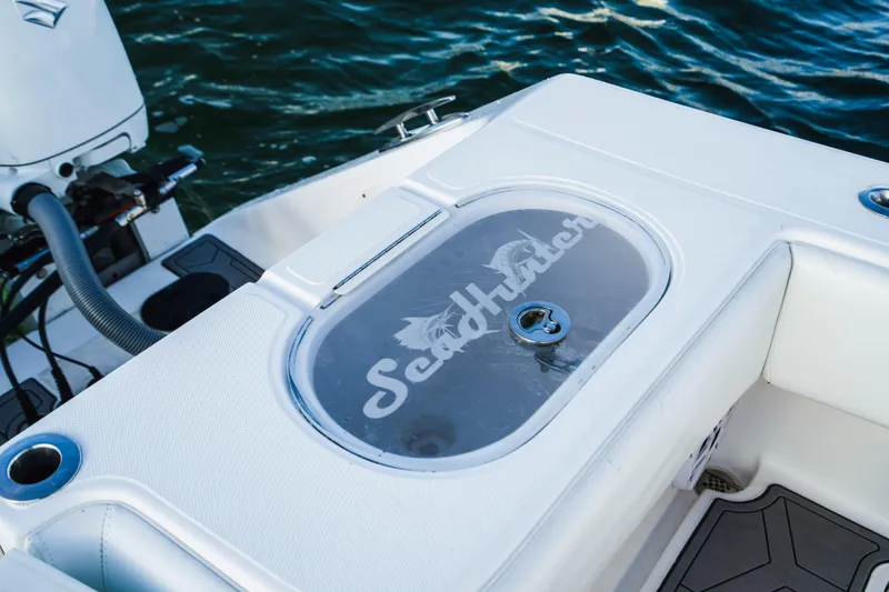 Slide: The Image of SeaHunter 39 Tournament 2018 boat deck with logo, near water. - 26