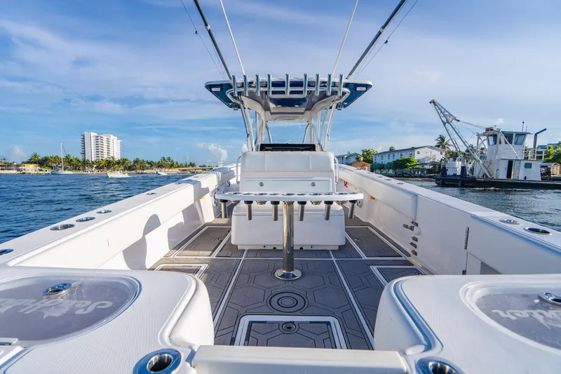 Slide: The Image of 2018 SeaHunter 39 Tournament boat on water, spacious deck, clear sky, coastal background. - 27