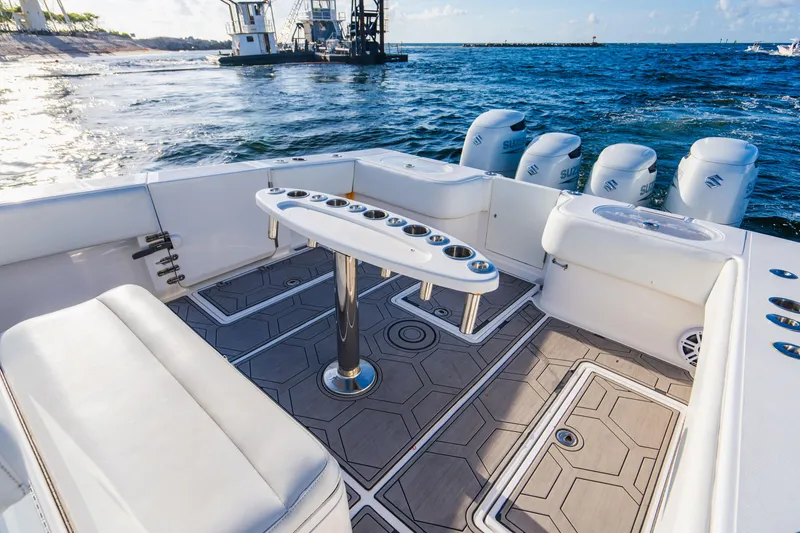 Slide: The Image of 2018 SeaHunter 39 Tournament boat interior with fishing rod holders and Suzuki engines. - 31