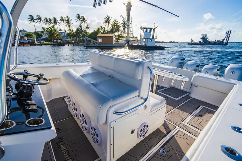 Slide: The Image of 2018 SeaHunter 39 Tournament boat interior with seating, ocean view, and palm trees. - 49