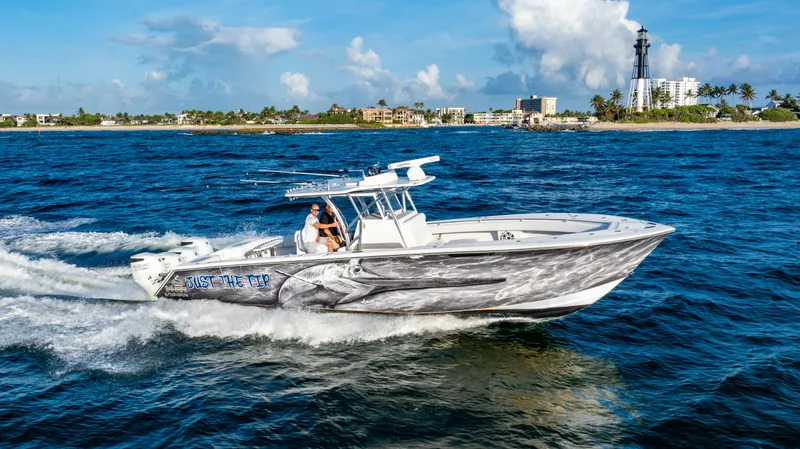 Slide: The Image of 2018 SeaHunter 39 Tournament boat cruising near a lighthouse on a sunny day. - 5