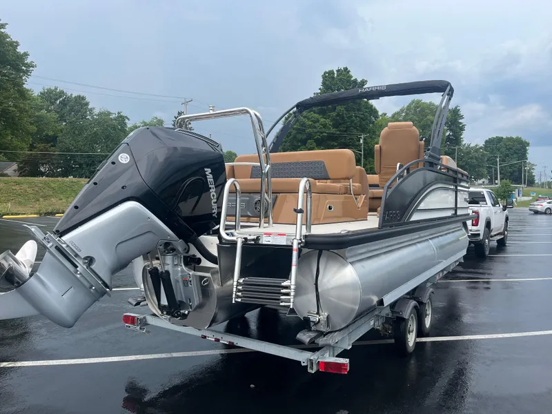 Slide: The Image of 2025 Harris Solstice 230 pontoon boat on trailer in parking lot. - 2