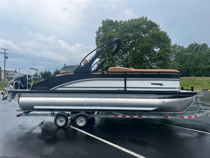 Slide: The Image of 2025 Harris Solstice 230 pontoon boat on trailer in parking lot. - 3
