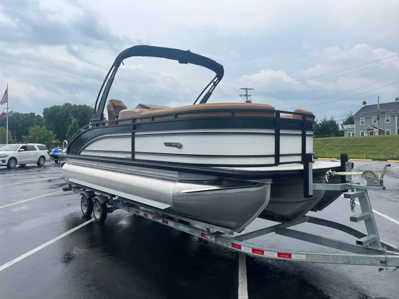 Slide: The Image of 2025 Harris Solstice 230 pontoon boat on trailer in parking lot. - 4