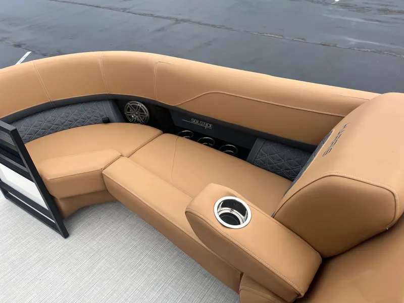 Slide: The Image of Luxurious seating on 2025 Harris Solstice 230 boat with tan upholstery and cup holders. - 8