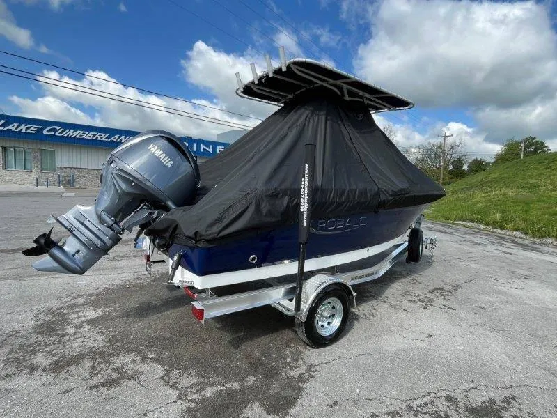 Slide: The Image of 2024 Robalo R180 boat with Yamaha engine, covered and on trailer, outdoors. - 14