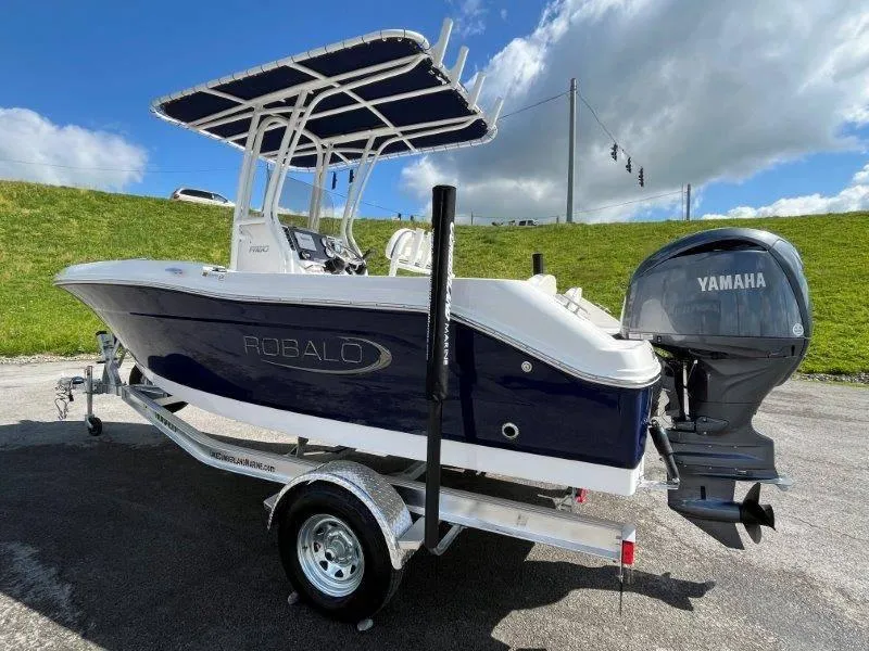 Slide: The Image of 2024 Robalo R180 boat with Yamaha engine on trailer, parked outdoors. - 16