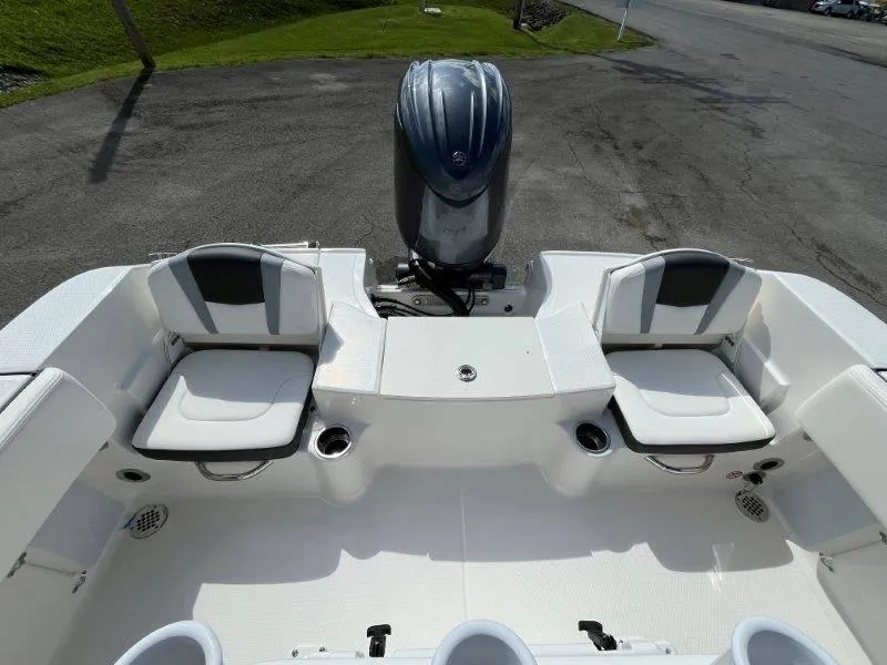 Slide: The Image of 2024 Robalo R180 boat interior with seating and outboard motor. - 18