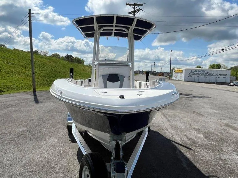 Slide: The Image of 2024 Robalo R180 boat on trailer, parked outdoors under cloudy sky. - 20
