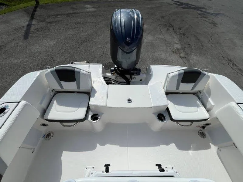 Slide: The Image of 2024 Robalo R180 boat interior with seating and motor, showcasing modern design. - 24