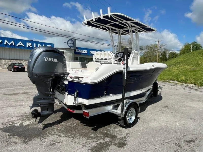 Slide: The Image of 2024 Robalo R180 boat with Yamaha engine on trailer, parked outdoors. - 27