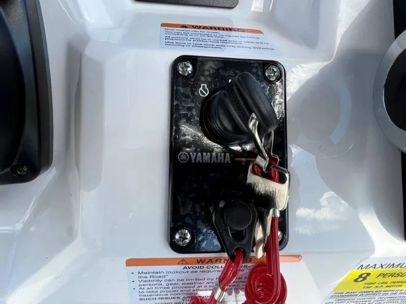 Slide: The Image of Yamaha ignition switch with keys on 2024 Robalo R180 boat dashboard. - 38