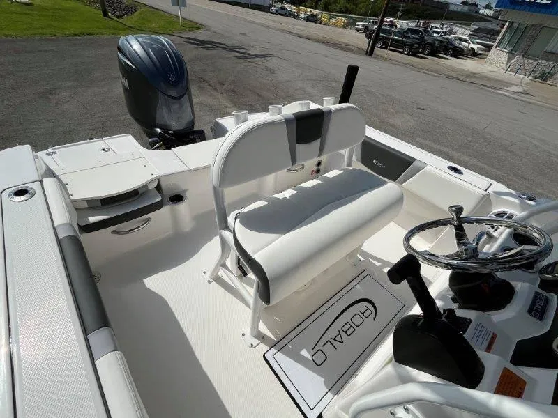 Slide: The Image of 2024 Robalo R180 boat interior with steering wheel and seating, showcasing modern design. - 47