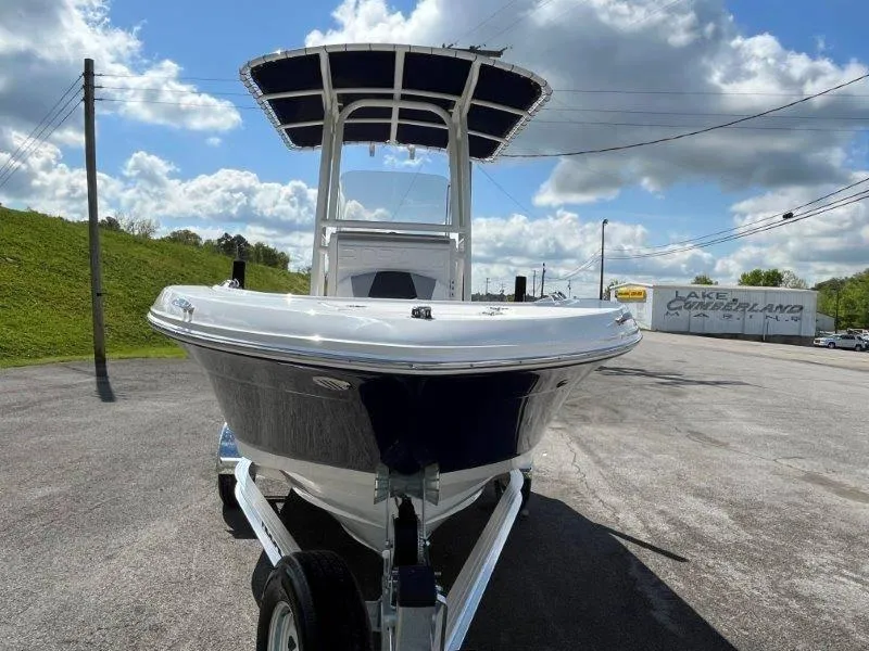 Slide: The Image of 2024 Robalo R180 boat on trailer under cloudy sky. - 48