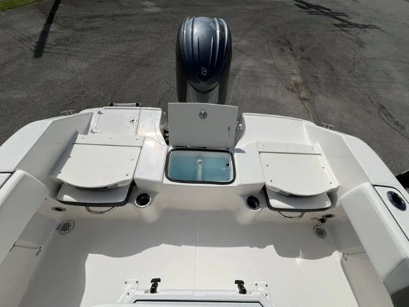 Slide: The Image of 2024 Robalo R180 boat interior with open storage compartments and engine view. - 49