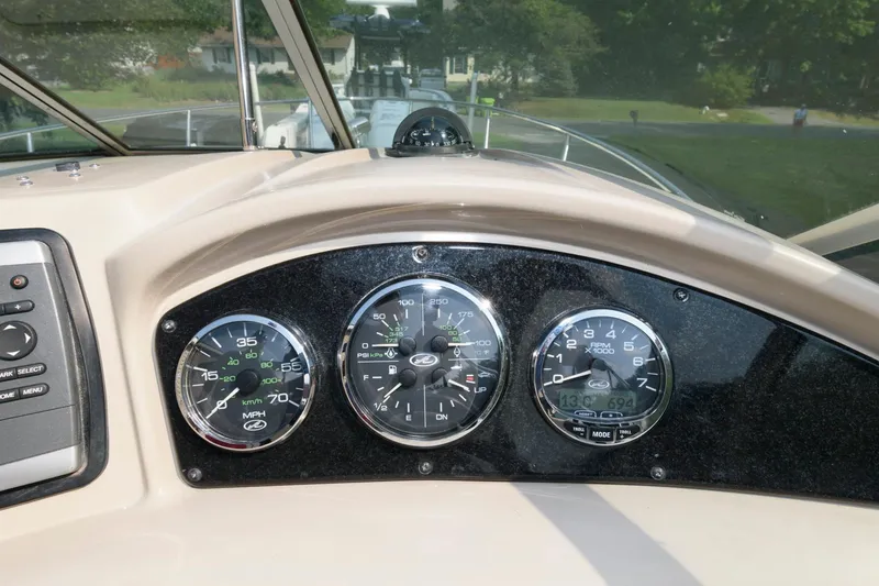 Slide: The Image of Dashboard of 2008 Sea Ray 240 Sundancer boat with gauges and controls. - 14