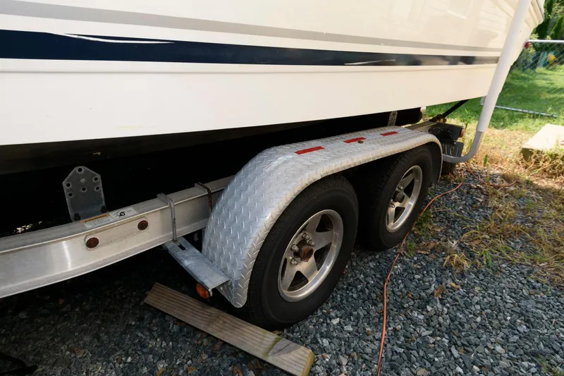 Slide: The Image of 2008 Sea Ray 240 Sundancer on trailer, close-up of wheels and hull. - 15