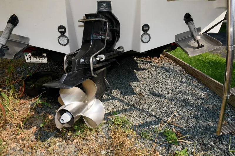 Slide: The Image of Rear view of 2008 Sea Ray 240 Sundancer boat propeller and outdrive on gravel. - 17