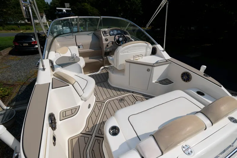Slide: The Image of 2008 Sea Ray 240 Sundancer boat interior with seating and steering console. - 3