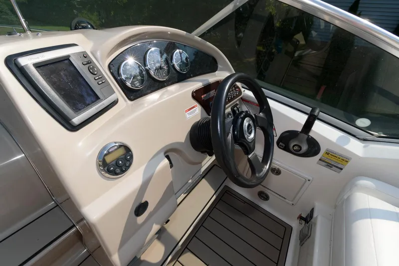 Slide: The Image of 2008 Sea Ray 240 Sundancer boat dashboard with steering wheel and navigation instruments. - 6