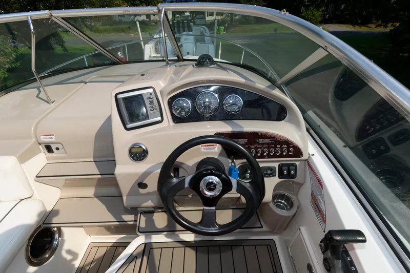 Slide: The Image of 2008 Sea Ray 240 Sundancer boat dashboard with steering wheel and gauges. - 7
